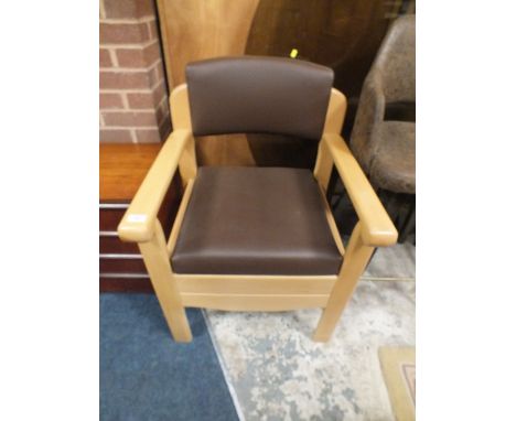 A MODERN UPHOLSTERED MOBILITY COMMODE ARM CHAIR