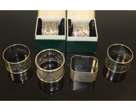 FOUR ASSORTED HALLMARKED SILVER NAPKIN RINGS, together with two 90% silver examples (6)