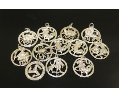 A BAG OF STERLING SILVER SIGNS OF THE ZODIAC PENDANTS 