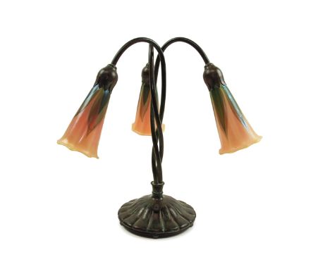 Buffalo Metal Works three light lily lamp in the  Art Nouveau taste, executed in patinated bronze,  having three curving stem