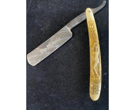 An antique victorian erotic themed celluoid handle cuthroat razor 