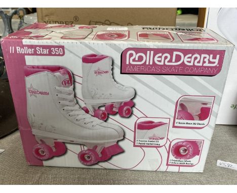 A boxed pair of child's roller skates size 2. 