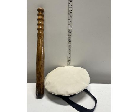 A wooden Truncheon and a sailors cap 