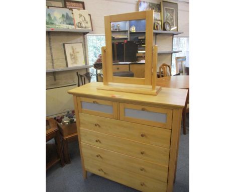 A modern light wood chest of drawers and matching dressing table mirror 