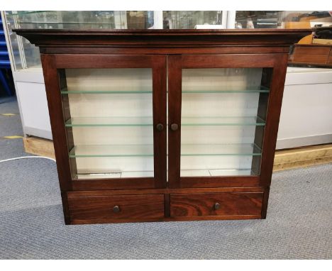 A hanging glazed mahogany display cabinet with fitted shelves, mirror and lighting inside 