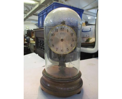 An early 20th century 800-day electric mantel clock, under a glass dome 27cm high Location: 