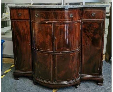 An Edwardian string inlay flame mahogany sideboard with shaped grey marble top, the bow fronted centre with a frieze drawer a