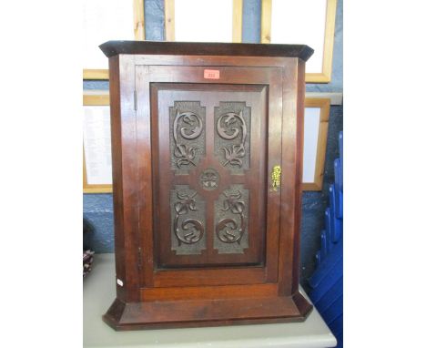 An early 20th century mahogany corner wall cupboard having a single carved door with the date 1906 to the reverse, 71cm x 52c