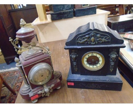 A Victorian black cased mantle clock with brass mounts, cream enamelled Arabic chapter ring and brass dial, movement striking