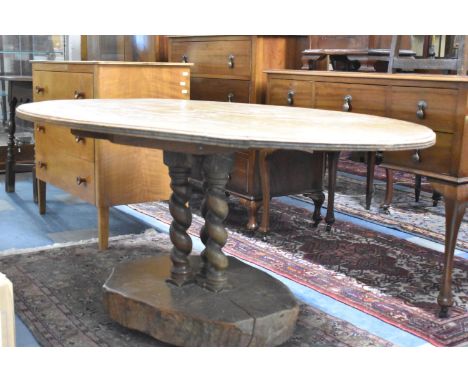 An Oval Topped Occasional Table on Three Barley Twist Supports Set Into Sawn Tree Trunk Base, 152cm Long