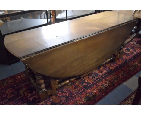 A Reproduction Oak Wake Table with Oval Top, Gate Leg Mechanism, 199cm long 