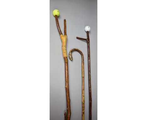 A Collection of Two Thumb Sticks and a Walking Stick 