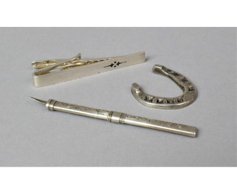 A Silver Toothpick, Silver Tie Clip and a Silver Lucky Charm in the Form of Horseshoe 