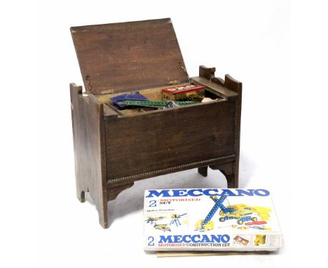 A c1930s wooden storage box with a large quantity of vintage Meccano to include vintage tins, OXO cubes, Craven etc, full of 