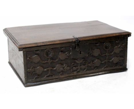 A 17th century oak Bible box with moulded lid which reveals a plain interior with candle box, iron hinges and clasp, later ad