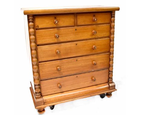 A Victorian mahogany two-over-four chest of drawers, turned column decoration to either side with turned knobs inset with mot