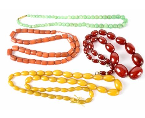 A green jade bead necklace and three amber-style necklaces (4).