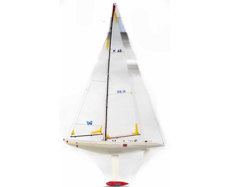 A large cream pond yacht with Union Jacks and Continental flags, large sails, K-85 and embellished with butterflies, length 9