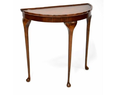 A Reprodux mahogany demi-lune console table with piecrust rim and raised on cabriole legs to pad feet, height 74cm, width 73c