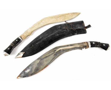 Two Indian kukris, one with scabbard and small knives, the other without (2).