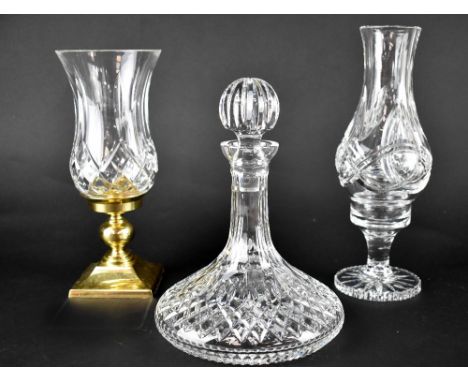 Three boxed Waterford Crystal items to include a ship's decanter, baluster vase on footed stand and a Trinity Hurricane candl