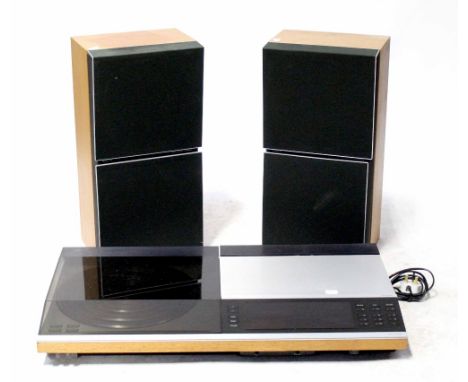 A Bang & Olufsen Beocenter 7007 stereo and a pair of Bang & Olufsen Beovox S45 speakers. CONDITION REPORT There is a turntabl