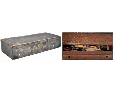 A vintage wooden tool chest with a quantity of hand tools to include planes, chisels, hammers, mallet, tape measure, large sa