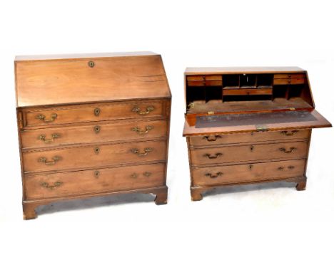 A 19th century bureau desk with drop-down desk top with interior drawers and pigeonholes with small turned knobs, narrow frie