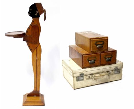 A vintage cream leather-effect suitcase, a single oak filing drawer, a double oak filing drawer and a dumb waiter, height 89c