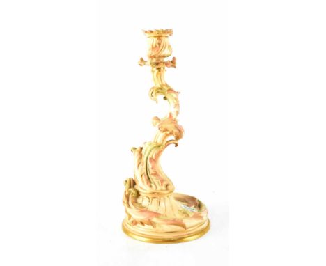 A Royal Worcester blush ornate single candlestick in the form of curving stem with leaves and tulip sconce, on a circular spr