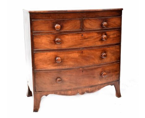 A 19th century bow-fronted mahogany chest of two short over three long graduated drawers with turned wooden handles, on outsw