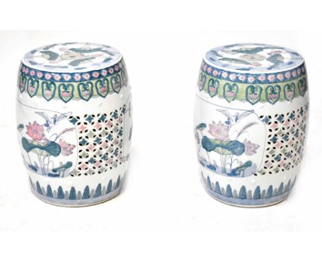 A pair of modern Chinese ceramic garden seats with pierced and painted lilypad and crane decoration, height 46cm (2).