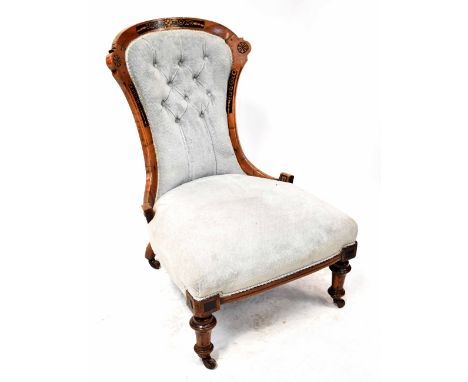 A Victorian inlaid walnut nursing chair upholstered in light blue, on turned tapering legs.