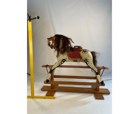 A vintage dapple grey rocking horse on trestle base, approximately 46 cm (h)

NOTE: ITEM IS LOCATED IN THE L34 POSTCODE AREA.