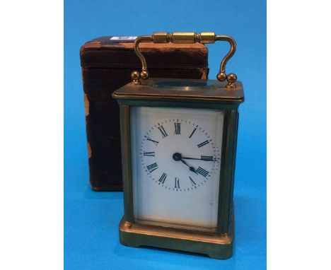 A brass four glass carriage clock together with fitted travel case