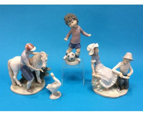 Three Lladro figure groups and a Nao figure group (4)