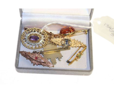 Collection of seven mostly gold brooches including amethyst and peridot examples