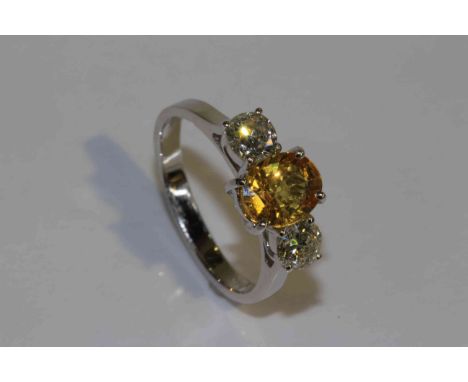 18 carat white gold oval yellow sapphire and brilliant diamond three stone ring