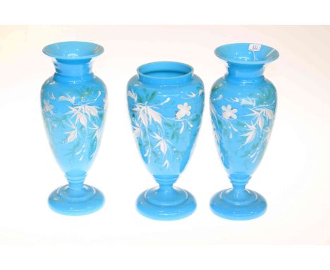 Garniture of three blue glass and enamel decorated vases