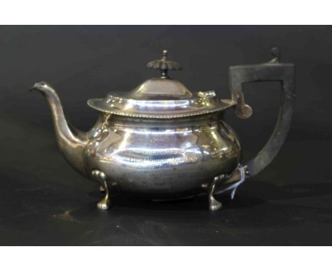 Silver teapot on paw feet