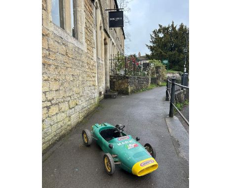 1960s LOTUS RACING PEDAL CAR BY TRIANG  In moulded plastic, circa 1970, finished in British racing green with yellow nose con