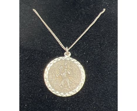 A boxed silver St. Christopher circular shaped pendant on a 16" silver fine curb chain. Pendant approx. 1.75cm diameter, stam