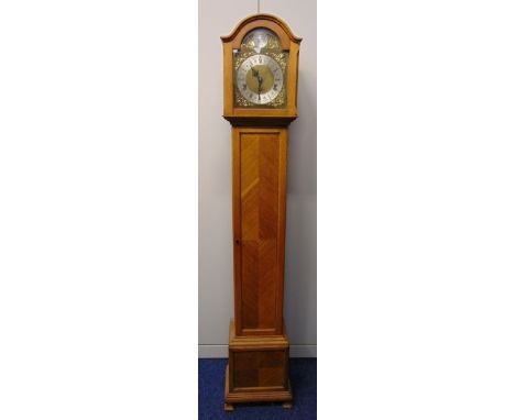 An oak cased grandmother clock the silvered dial with Roman numerals, two train movement, the pedestal base on four bracket s