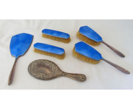 A five piece hallmarked silver and enamel dressing table set to include a hand mirror, clothes and hair brushes and a hallmar