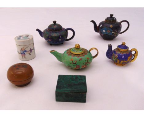 Four miniature cloisonné teapots, a malachite box and cover, a ceramic covered box and a metal covered box (7)