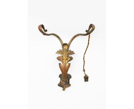An Art Nouveau gilded metal twin-branch wall light in the manner of WAS Benson, the twin branches flanked with foliate panel 