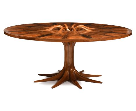 ‡A large American walnut circular table by Robin Williams, the top with sixteen figured walnut veneer panels, the edge with t