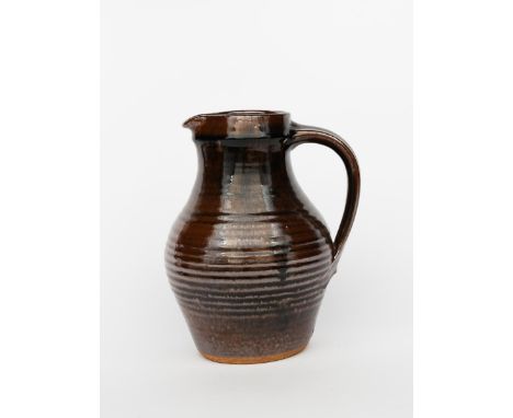 ‡David Leach OBE (1911-2005) a Lowerdown Pottery stoneware jug, covered in a tenmoku glaze, impressed seal marks, 27cm. high