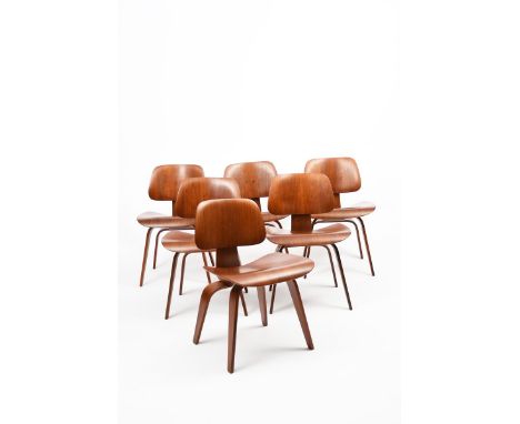 A set of six Herman Miller LCW chairs designed by Charles Eames, bent plywood, applied manufacturers labels, 73cm. high, (6) 