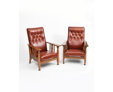 A pair of Liberty &amp; Co oak reclining armchairs,  the arms with simple carved slat support, with padded red leather seat a